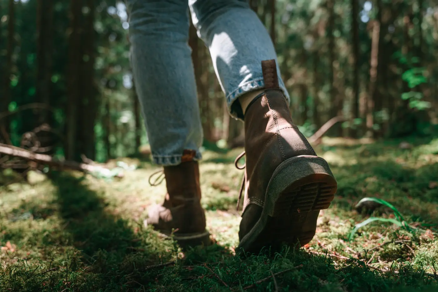 Walking boot in the forest with leaves stuck to the sole, symbolising the journey of emotional resilience and therapy for sensitivity