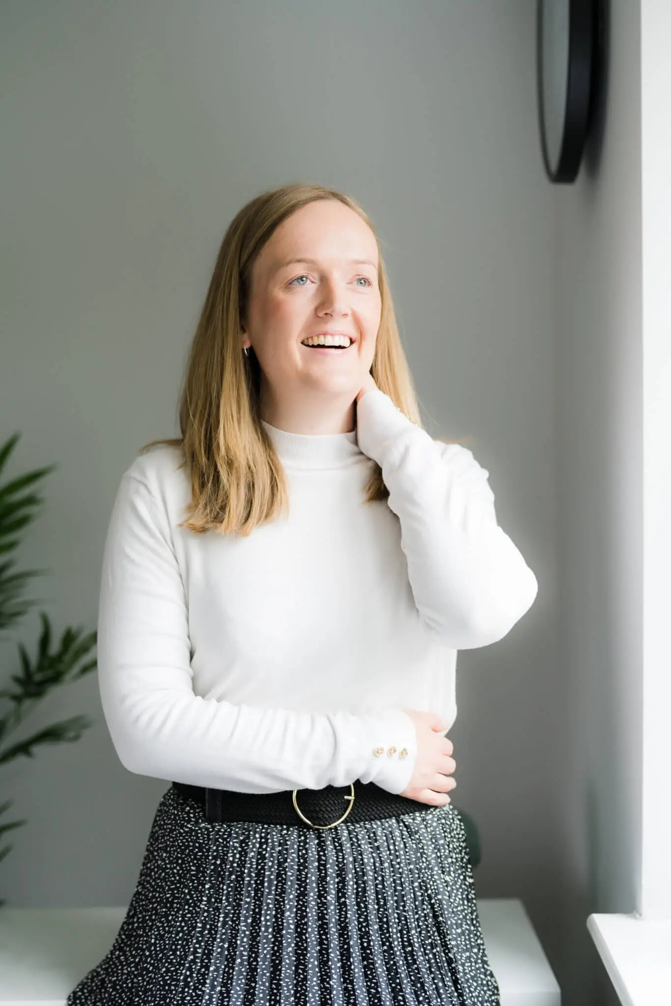 Emma Pott Smiling with Hand on Neck